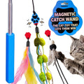A cat toy set shown on a white background with a gray tabby cat reaching for one of the dangling toys. The set includes a blue handle, metal pole, black cord, feather, pom-poms, red toy heads, and a blue paw-print charm.