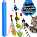 A cat toy set featuring a blue magnetic catch wand with dangling feather and pom-pom accessories, shown alongside a gray tabby cat reaching for the toy. A blue product badge reads 'MAGNETIC CATCH WAND' and 'THE CAT TOY THAT LETS THEM WIN.